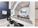 Wet bar with granite countertops and modern stools near stairway at 28 Vista Outlook St, Henderson, NV 89011