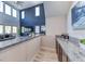 Wet bar with granite countertops and wood cabinets in the living room at 28 Vista Outlook St, Henderson, NV 89011