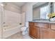 Bathroom with granite countertop, undermount sink, and white tile shower over tub at 28 Vista Outlook St, Henderson, NV 89011
