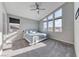 Bright bedroom with high windows, a ceiling fan, and a comfortable bed with blue accents at 28 Vista Outlook St, Henderson, NV 89011
