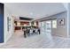 Open-concept dining room with modern table, chairs, and a view of the backyard and kitchen at 28 Vista Outlook St, Henderson, NV 89011