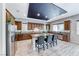 Open kitchen with dark wood cabinetry, granite countertops, and stainless steel appliances at 28 Vista Outlook St, Henderson, NV 89011