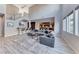 Bright, open living room with high ceilings, a staircase, modern decor, and luxury vinyl flooring at 28 Vista Outlook St, Henderson, NV 89011