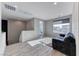 Bright living room features a comfortable gray sofa, light flooring and natural light at 28 Vista Outlook St, Henderson, NV 89011