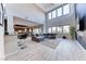 Expansive living space boasting a tall wall of windows, comfortable seating, and a cozy fireplace at 28 Vista Outlook St, Henderson, NV 89011