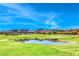 Picturesque view of a pond nestled within a lush golf course, with mountains in the background at 28 Vista Outlook St, Henderson, NV 89011
