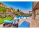 A luxurious backyard oasis featuring a stunning pool, spa, and comfortable lounge seating area at 28 Vista Outlook St, Henderson, NV 89011