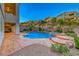 Beautiful backyard pool featuring a rock waterfall, spa, and lush tropical landscaping at 28 Vista Outlook St, Henderson, NV 89011