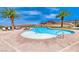 Community pool featuring mature palm trees with mountain views at 28 Vista Outlook St, Henderson, NV 89011