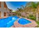 Stunning pool and spa combo with lush landscaping create a serene outdoor oasis at 28 Vista Outlook St, Henderson, NV 89011