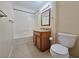 Cozy bathroom featuring a shower over tub, a wooden vanity and a standard toilet at 3038 Tarpon Dr # 103, Las Vegas, NV 89120