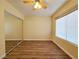 Bedroom view showcasing the laminate floor and mirrored closet doors that amplify light and space at 3038 Tarpon Dr # 103, Las Vegas, NV 89120