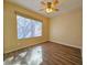 Bright bedroom with contemporary laminate floors, a ceiling fan and a large window for natural light at 3038 Tarpon Dr # 103, Las Vegas, NV 89120