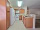 Kitchen featuring modern appliances, tile floors, and a breakfast bar to the living room at 3038 Tarpon Dr # 103, Las Vegas, NV 89120