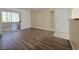 Spacious living area showcasing wood-look flooring, natural light, and a sliding glass door, offering a versatile and inviting space at 3038 Tarpon Dr # 103, Las Vegas, NV 89120