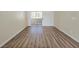Bright living room featuring wood-look floors and sliding glass doors at 3038 Tarpon Dr # 103, Las Vegas, NV 89120