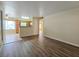 Spacious living room with wood-look floors leading to an open kitchen and dining area at 3038 Tarpon Dr # 103, Las Vegas, NV 89120