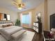 Staged bedroom featuring a ceiling fan and plenty of natural light from the window at 3038 Tarpon Dr # 103, Las Vegas, NV 89120