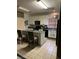 Bright kitchen featuring white cabinetry, black appliances, a center island with granite countertops and tile flooring at 312 Sierra Breeze Ave, North Las Vegas, NV 89031