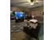 Cozy living room featuring a large sectional sofa, a modern TV, and soft carpet under warm, ambient lighting at 312 Sierra Breeze Ave, North Las Vegas, NV 89031