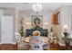 Cozy dining area featuring a round wood table, decorative chandelier, and an elegant display cabinet at 3185 Mura Del Prato Ave, Henderson, NV 89044