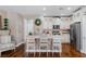 Bright, updated kitchen with white cabinets, stainless steel appliances, and an island with seating at 3185 Mura Del Prato Ave, Henderson, NV 89044