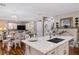 Open-concept kitchen and living area with hardwood floors, bright lighting, and comfortable furnishings at 3185 Mura Del Prato Ave, Henderson, NV 89044