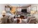 Comfortable living room boasts hardwood floors, plush seating, and large windows with plantation shutters at 3185 Mura Del Prato Ave, Henderson, NV 89044