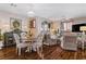 Open-concept living space with dining area, living room, hardwood floors, and decorative accents at 3185 Mura Del Prato Ave, Henderson, NV 89044