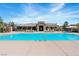 Community pool and clubhouse surrounded by lounge chairs and well-maintained landscaping at 3185 Mura Del Prato Ave, Henderson, NV 89044