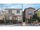 View of a neighborhood street featuring well-maintained townhomes with inviting entrances and landscaping at 3185 Mura Del Prato Ave, Henderson, NV 89044