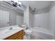 Bathroom with shower over tub, large mirror and vanity with wood cabinets at 331 Seine Way # 331, Henderson, NV 89014