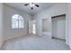 Bedroom featuring carpet, closet with mirrored doors, and an arched window at 331 Seine Way # 331, Henderson, NV 89014
