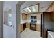 Kitchen featuring black appliances, light wood cabinets, tile backsplash and window with a view at 331 Seine Way # 331, Henderson, NV 89014