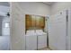 Laundry area inside closet with overhead cabinets and full size washer and dryer at 331 Seine Way # 331, Henderson, NV 89014
