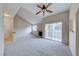 Bright living room with vaulted ceilings, neutral carpet, fireplace and sliding door to patio at 331 Seine Way # 331, Henderson, NV 89014