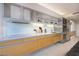 Modern kitchen featuring white countertops, sleek wood cabinets, stainless steel appliances, and tiled floors at 3726 Las Vegas Blvd # 609, Las Vegas, NV 89158