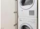 Stacked Bosch washer and dryer unit with a white cabinet door ajar, showcasing a compact laundry solution at 3726 Las Vegas Blvd # 609, Las Vegas, NV 89158