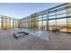 Indoor pool area featuring lounge chairs and views of the city skyline through large windows at 3726 Las Vegas Blvd # 609, Las Vegas, NV 89158
