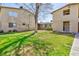 Lawn area behind an apartment building and units with light-colored walls at 3821 1/2 Daisy St # 26, Las Vegas, NV 89119