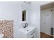 Bathroom with modern black hardware, mosaic-style backsplash and new flooring at 3821 1/2 Daisy St # 26, Las Vegas, NV 89119