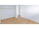Bedroom with closet, bright white walls, wood-look flooring, and updated lighting at 3821 1/2 Daisy St # 26, Las Vegas, NV 89119
