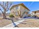 Two-story tan apartment building features a sidewalk and minimal landscaping at 3821 1/2 Daisy St # 26, Las Vegas, NV 89119