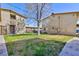 Apartment building exterior showing a green space and a sidewalk at 3821 1/2 Daisy St # 26, Las Vegas, NV 89119