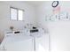 White laundry machines in community room with wall-mounted instructions and warnings at 3821 1/2 Daisy St # 26, Las Vegas, NV 89119