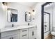 Modern bathroom with double sinks, quartz countertops, black fixtures, and shower with glass door at 3911 Kamden Way, Las Vegas, NV 89119