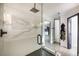 Bathroom showcasing a sleek glass shower with marble-style walls and black hardware at 3911 Kamden Way, Las Vegas, NV 89119
