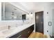 Bright bathroom featuring a long vanity with modern fixtures, and a glass enclosed shower at 3911 Kamden Way, Las Vegas, NV 89119