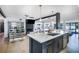 Island Kitchen with quartz countertop, stainless steel appliances and bar seating at 3911 Kamden Way, Las Vegas, NV 89119