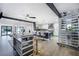 Open kitchen boasts stainless steel appliances, island with seating, wine rack, and natural light at 3911 Kamden Way, Las Vegas, NV 89119